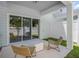 Back patio with seating and a view of the lawn through a sliding glass door at 393 Meadowland Pt, Oviedo, FL 32765
