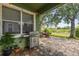 Covered patio with stone pavers, outdoor grill, backyard pond view and overhead string lights at 4813 River Gem Ave, Windermere, FL 34786