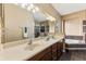 Bathroom featuring double sinks, granite counters, a large mirror, and a large tub at 4813 River Gem Ave, Windermere, FL 34786