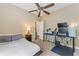 Cozy bedroom with neutral walls, ceiling fan, and a computer setup at 4813 River Gem Ave, Windermere, FL 34786