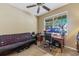 Comfortable bedroom with neutral carpet, ceiling fan, a futon and a computer desk at 4813 River Gem Ave, Windermere, FL 34786
