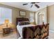 Cozy bedroom featuring two windows, side tables with lamps, and carpet flooring at 4813 River Gem Ave, Windermere, FL 34786