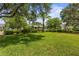 Expansive lawn area with shade trees, manicured shrubs, and covered structures for community enjoyment at 4813 River Gem Ave, Windermere, FL 34786