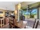 Dining area with view of outdoor patio, backyard and connecting living room with hardwood floors at 4813 River Gem Ave, Windermere, FL 34786