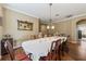 Formal dining room featuring a large table, elegant chandelier, and hardwood floors at 4813 River Gem Ave, Windermere, FL 34786