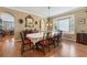 Dining room featuring a large table with windows and hardwood floors at 4813 River Gem Ave, Windermere, FL 34786