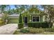 Charming green home with a well-manicured front yard and inviting entryway at 4813 River Gem Ave, Windermere, FL 34786