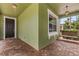 Inviting front porch with brick flooring, swing and views of lush landscaping at 4813 River Gem Ave, Windermere, FL 34786