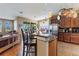 Spacious kitchen with island and breakfast bar overlooking the living area and stainless steel refrigerator at 4813 River Gem Ave, Windermere, FL 34786
