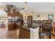 Kitchen with granite counters, stainless steel appliances, wooden cabinets, and a hanging pot rack at 4813 River Gem Ave, Windermere, FL 34786
