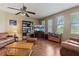Bright living room with ceiling fan, laminate floors, large windows, and comfortable sofas at 4813 River Gem Ave, Windermere, FL 34786