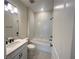 Bathroom with shower-tub combo, modern vanity, and matte black fixtures at 5158 Gardenrow Dr, St Cloud, FL 34772