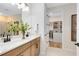 Modern bathroom features double vanity, granite countertops, a walk-in closet, and stylish fixtures at 5158 Gardenrow Dr, St Cloud, FL 34772