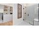 Modern bathroom showing walk-in shower, with tiled walls, and a spacious walk-in closet with shelving at 5158 Gardenrow Dr, St Cloud, FL 34772