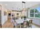 Dining area with stylish light fixture flowing into an open kitchen with stainless steel appliances at 5158 Gardenrow Dr, St Cloud, FL 34772