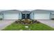 Charming attached villa featuring an attached two-car garage, landscaped yard, and brick paver driveway at 5158 Gardenrow Dr, St Cloud, FL 34772
