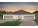 Stylish single story home with a brick paved driveway and a well-manicured green space at 5158 Gardenrow Dr, St Cloud, FL 34772