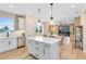 Open-concept kitchen with island, stainless appliances, and connection to dining and living areas at 5158 Gardenrow Dr, St Cloud, FL 34772