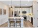 Modern kitchen features stainless steel appliances, sleek white cabinets, pendant lighting, and center island at 5158 Gardenrow Dr, St Cloud, FL 34772