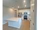 Modern kitchen featuring white cabinets, stainless steel appliances, a kitchen island, and wood flooring at 5158 Gardenrow Dr, St Cloud, FL 34772