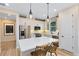 Bright kitchen boasts stainless steel appliances, white cabinets, center island with seating, and modern pendant lights at 5158 Gardenrow Dr, St Cloud, FL 34772
