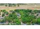 Aerial view of a home nestled in lush greenery with a race track in the distance at 549 Wellon Ave, Orlando, FL 32833