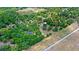 An aerial view of a home with a vast tree coverage. The image also includes a speedway and a highway at 549 Wellon Ave, Orlando, FL 32833