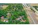An aerial view of a home with a vast tree coverage. The image also includes a speedway and a highway at 549 Wellon Ave, Orlando, FL 32833