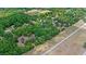 An aerial view of a home with a vast tree coverage. The image also includes a speedway and a highway at 549 Wellon Ave, Orlando, FL 32833
