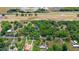 An aerial view of a home with a vast tree coverage. The image also includes a speedway and a highway at 549 Wellon Ave, Orlando, FL 32833
