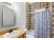 Well-lit bathroom featuring a vanity, mirror, and a tub-shower combination at 549 Wellon Ave, Orlando, FL 32833