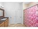 Bright bathroom features a shower with glass doors and a floral shower curtain at 549 Wellon Ave, Orlando, FL 32833