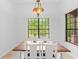 Bright dining room with beautiful light fixture and a large window with a backyard view at 549 Wellon Ave, Orlando, FL 32833