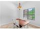 This dining room features a rustic wood table, beautiful light fixture, and a large window with outside view at 549 Wellon Ave, Orlando, FL 32833