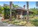 A beautiful home featuring a screened front porch, mature trees and lush green lawn at 549 Wellon Ave, Orlando, FL 32833