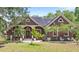 Charming single-Gathering home featuring a well-manicured lawn, mature trees, and a covered front porch at 549 Wellon Ave, Orlando, FL 32833