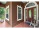 Charming front porch with rocking chairs, tile flooring, windows, and a beautiful front door at 549 Wellon Ave, Orlando, FL 32833