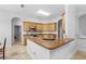 This kitchen boasts tile floors, wooden cabinets, stainless appliances, and a breakfast bar at 549 Wellon Ave, Orlando, FL 32833