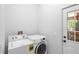 Laundry room with a washer and dryer and a door to the exterior at 549 Wellon Ave, Orlando, FL 32833