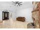 Inviting living room with tile floors, stone fireplace, ceiling fan, and lots of natural light at 549 Wellon Ave, Orlando, FL 32833