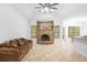 Bright living room featuring a unique stone fireplace, tile flooring, ceiling fan, and serene backyard views at 549 Wellon Ave, Orlando, FL 32833