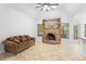 Open-concept living space with beautiful stone fireplace, ceiling fan, and tile floors at 549 Wellon Ave, Orlando, FL 32833