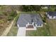 Aerial view of home featuring manicured landscaping and a paved drive leading to the attached garage at 6054 Sw 154Th Place Rd, Ocala, FL 34473