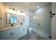 Modern bathroom with double vanity, glass shower, and sleek fixtures at 6054 Sw 154Th Place Rd, Ocala, FL 34473