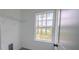View of a walk-in closet featuring a window view and storage shelves, providing ample space at 6054 Sw 154Th Place Rd, Ocala, FL 34473