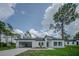 Charming single-story home features a gray garage door, white exterior, and well-maintained front yard at 6054 Sw 154Th Place Rd, Ocala, FL 34473