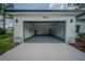 Spacious two-car garage with high ceilings, gray floor and garage door with ample lighting at 6054 Sw 154Th Place Rd, Ocala, FL 34473