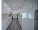 Modern kitchen with white cabinets, stainless steel appliances, and a spacious center island at 6054 Sw 154Th Place Rd, Ocala, FL 34473