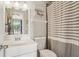 Clean bathroom with a vanity, toilet, and shower with a striped curtain, creating a relaxing space at 620 Fruitwood Ave, Winter Springs, FL 32708