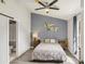 Cozy bedroom with a gray accent wall, featuring a neutral color palette and ensuite bathroom at 620 Fruitwood Ave, Winter Springs, FL 32708